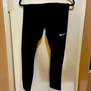 NWT NIKE Size M- Tight fit running pants with mesh lower leg. Black w/white LOGO